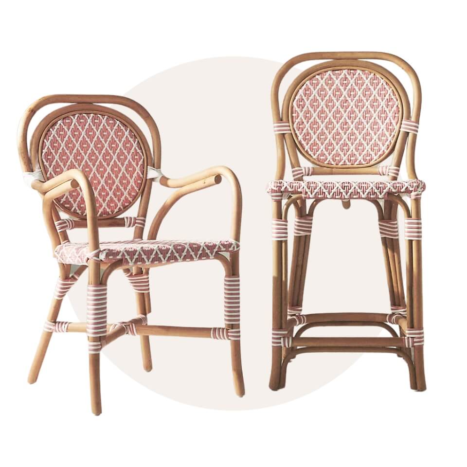 A dining chair and stool with wicker frames and red-and-white seats