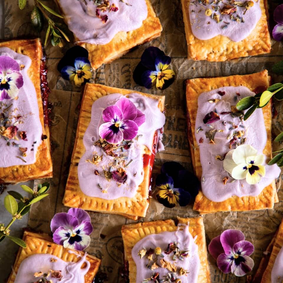 Pop tarts with light purple frosting and edible flowers on top