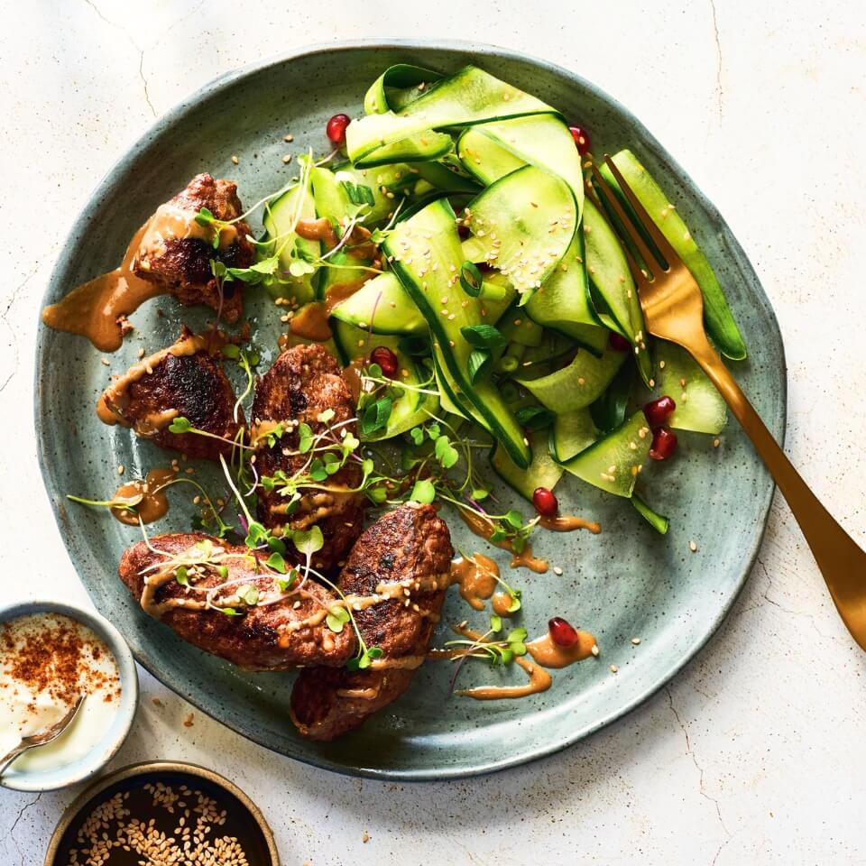 A blue plate with beef and salad