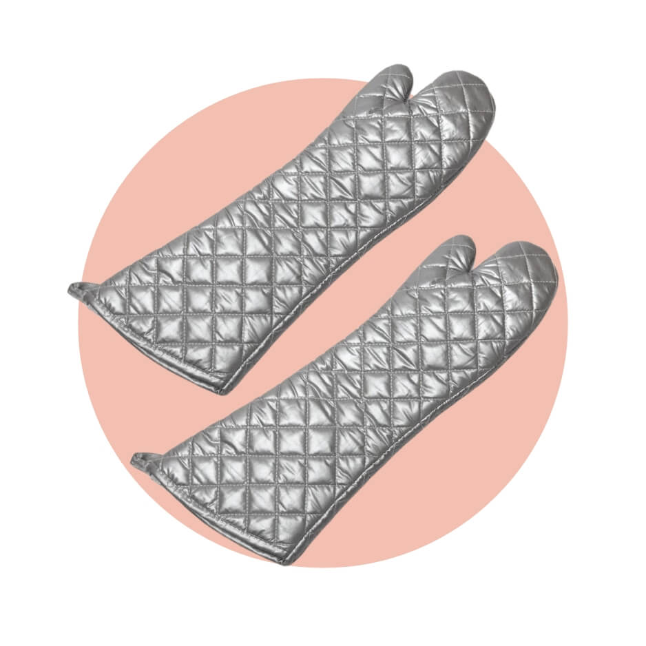Two elbow-length silver oven mitts over a light pink circle