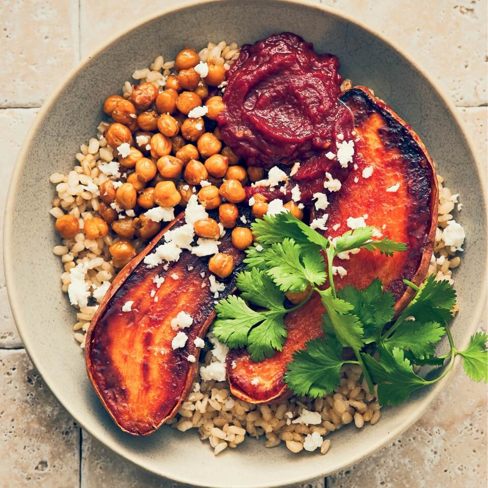 A dish with roasted sweet potatoes, chickpeas and other healthy ingredients