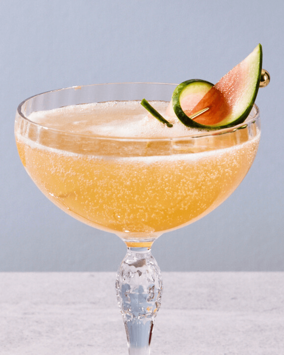 close-up photo of a cocktail with watermelon garnish