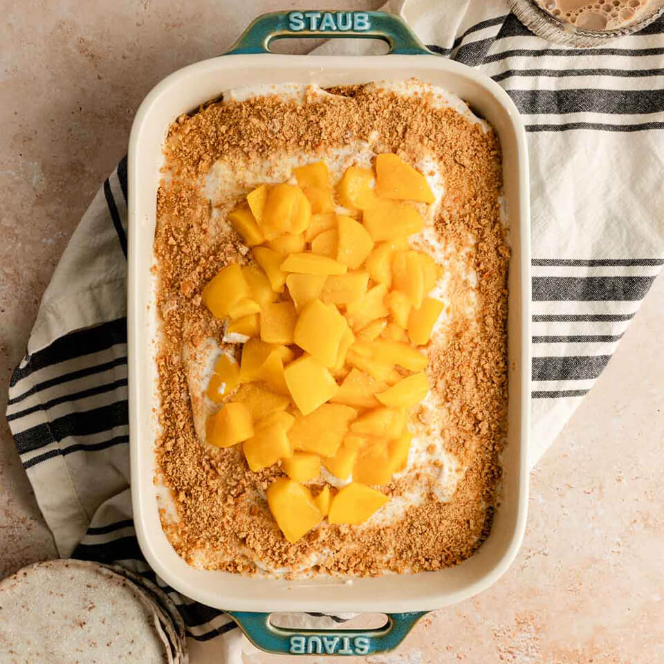 A vegan mango float recipe is possible, and this is what Keisha of The Floured Frame has created and made in a Staub casserole dish with chunks of mango on top. 