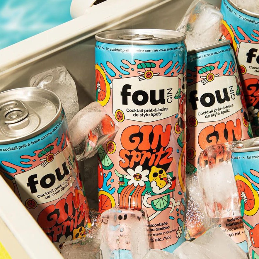 Cans of a drink in a cooler with swimming pool water visible behind them