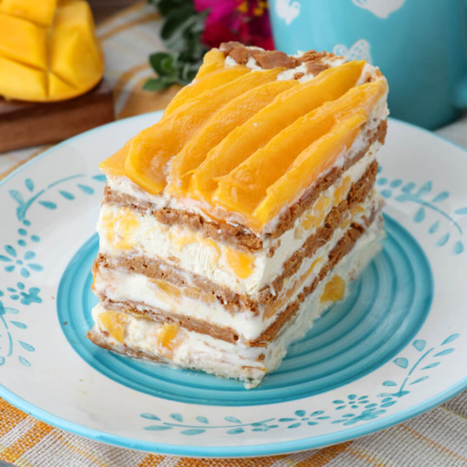 This layered mango float is a traditional Filipino recipe and has layers of heavy cream, graham crackers and slivers of mango.