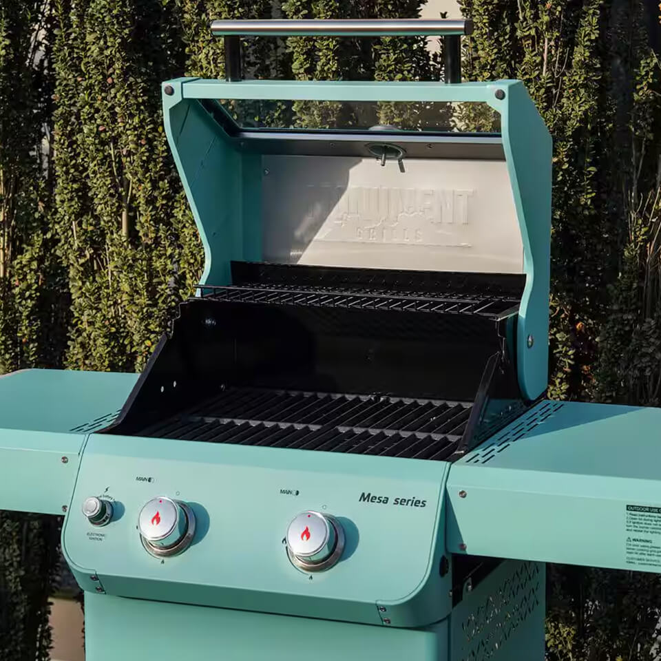 A small turquoise grill with the lid open