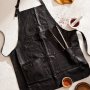 A black leather apron with dishes of spice rubs around it