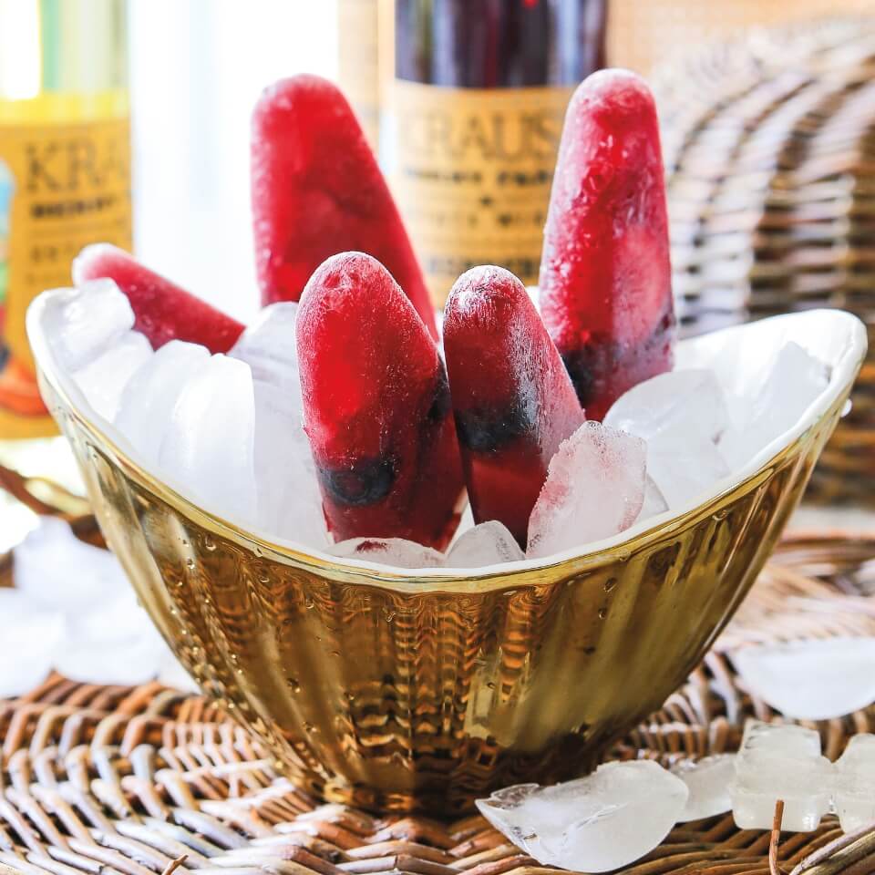 A gold bucket with frozen popsicles on ice
