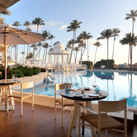 outdoor dining tables beside pool in caribbean