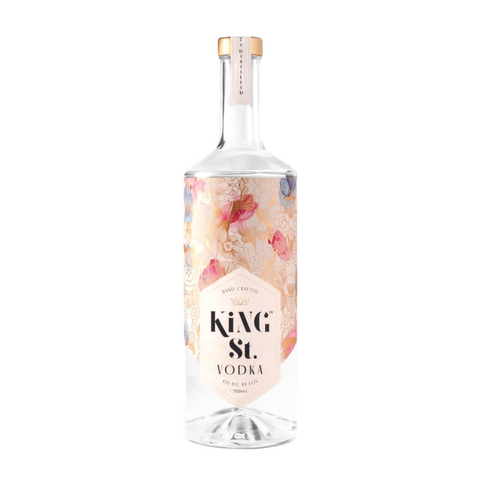 A bottle of vodka with a pink floral label
