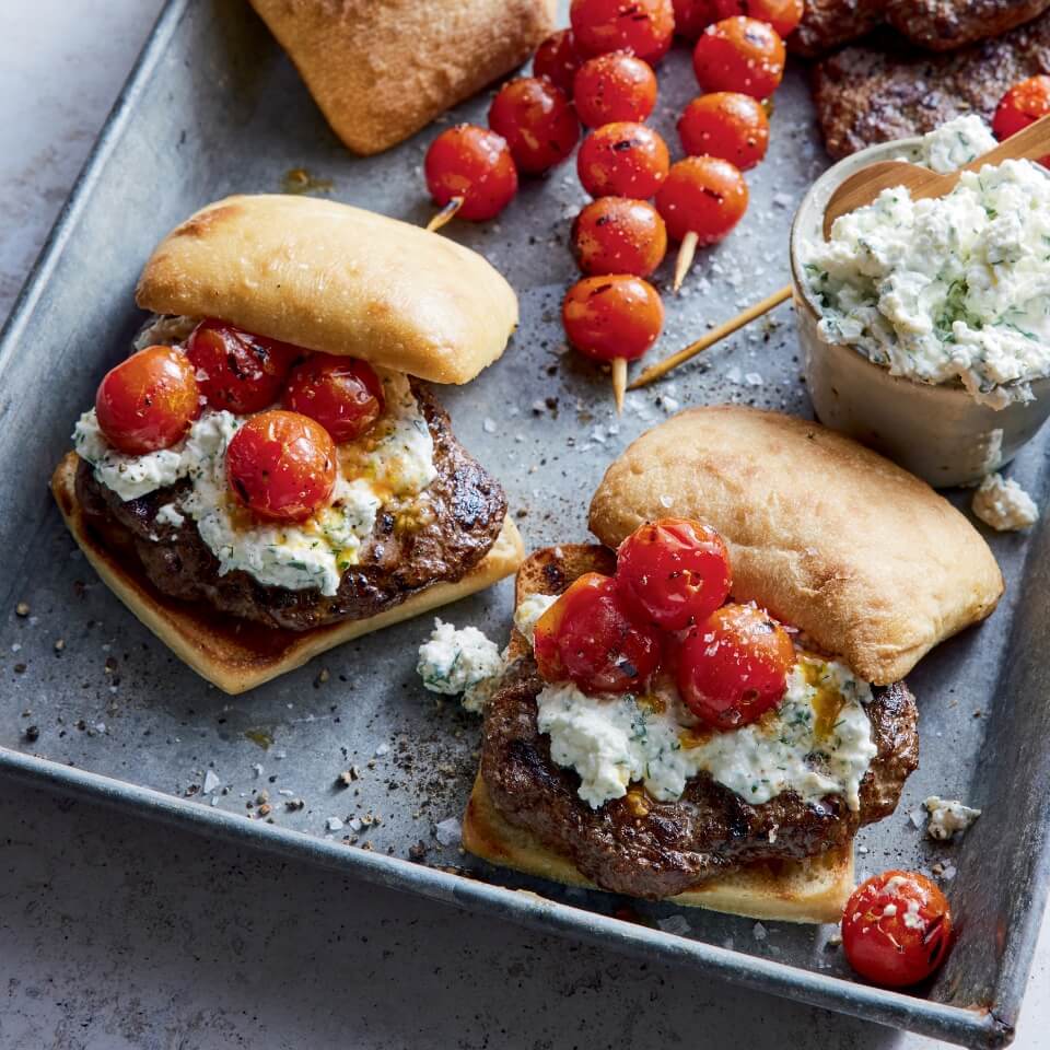 Burgers with feta cheese and cherry tomatoes
