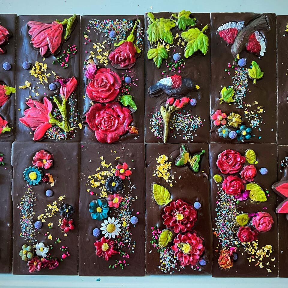 A closeup of chocolate bars with edible flowers in them