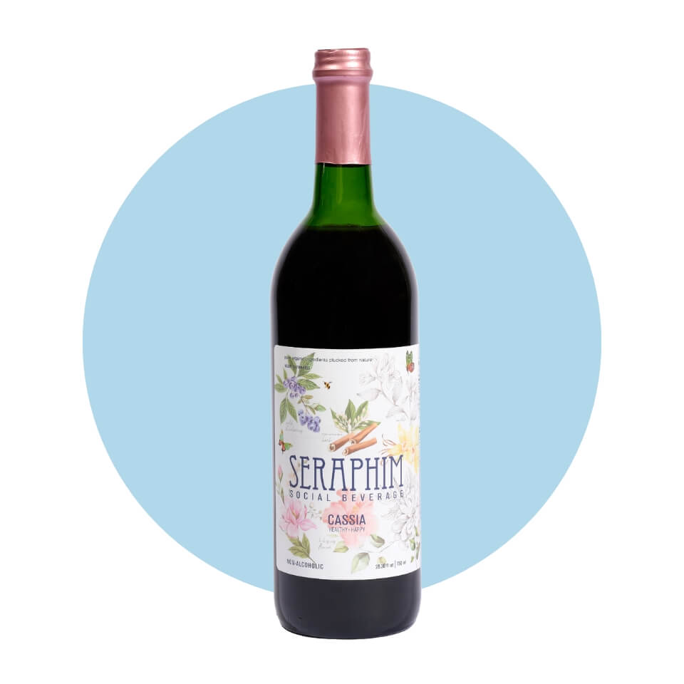 A wine bottle with a floral label and pink foil cap over a light blue circle