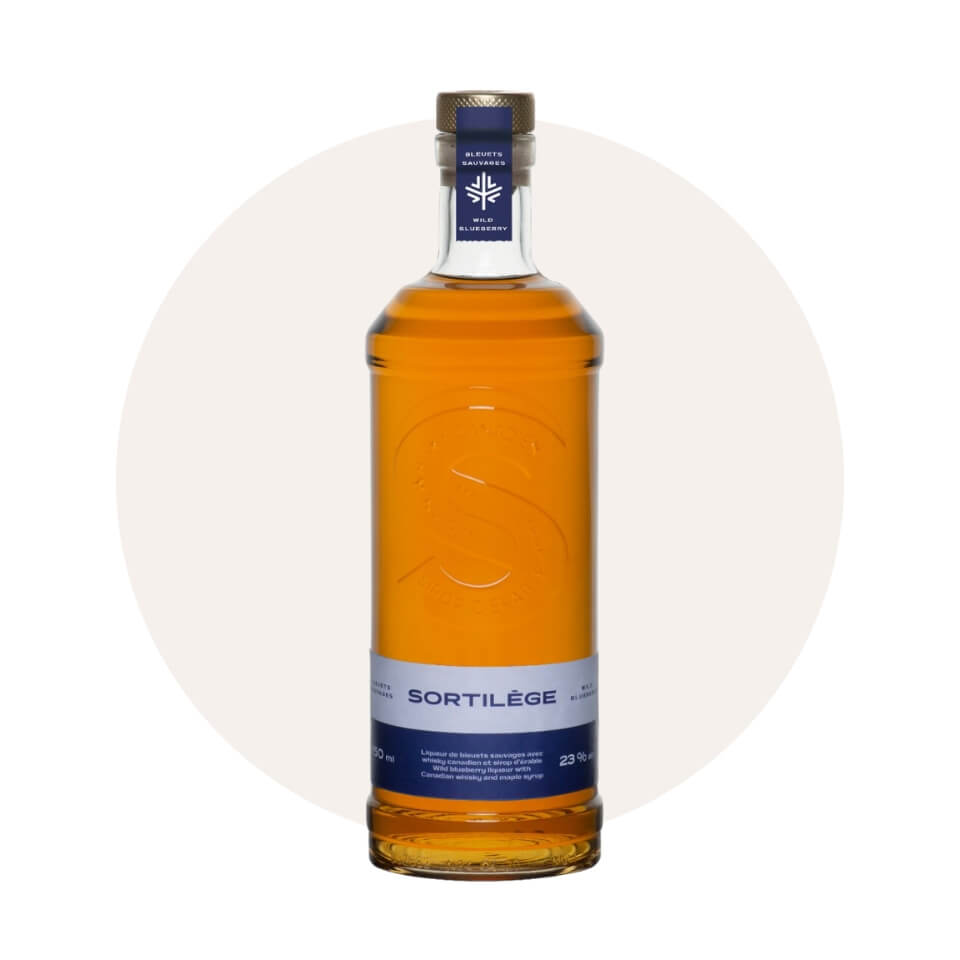 A bottle of whisky with a blue label over a cream-coloured circle