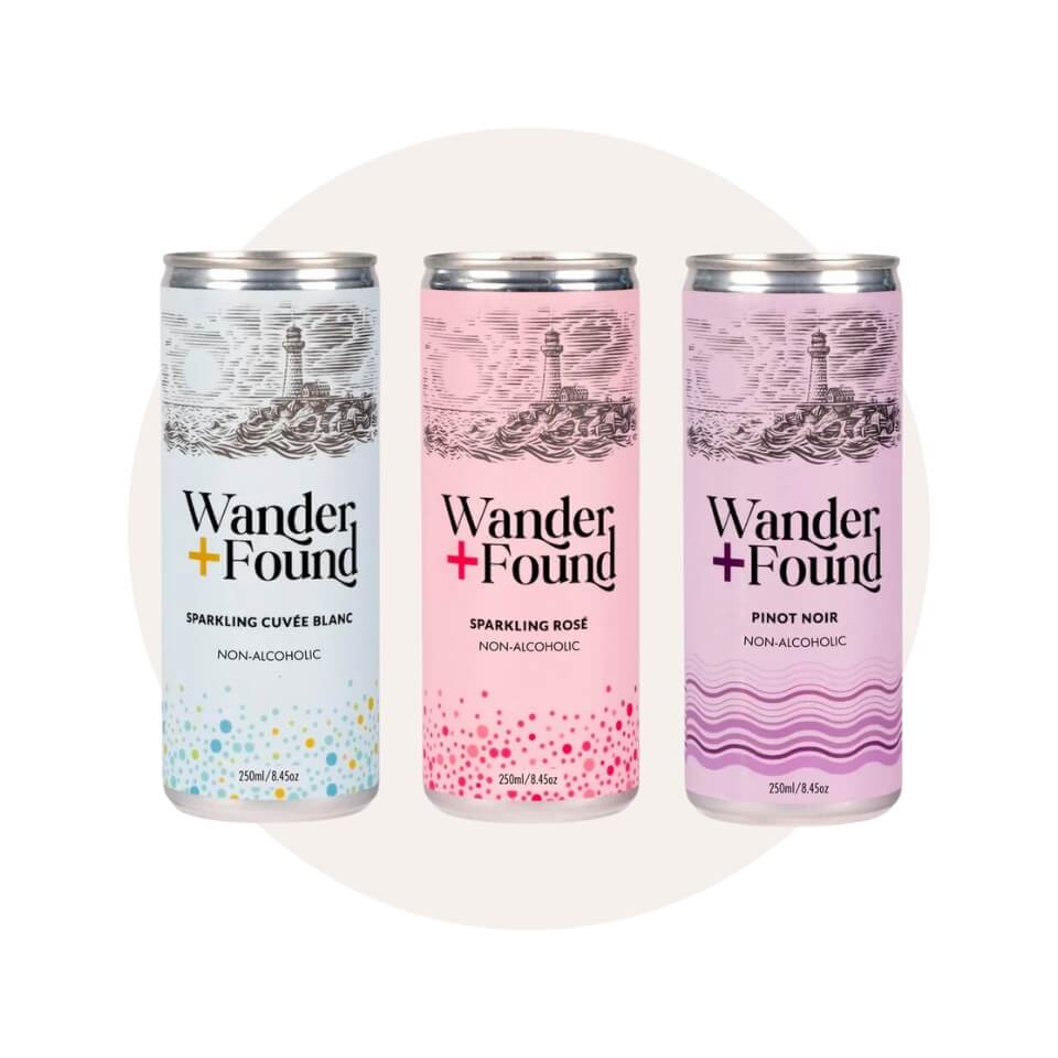 A light blue can, pink can and purple can over a cream-coloured circle