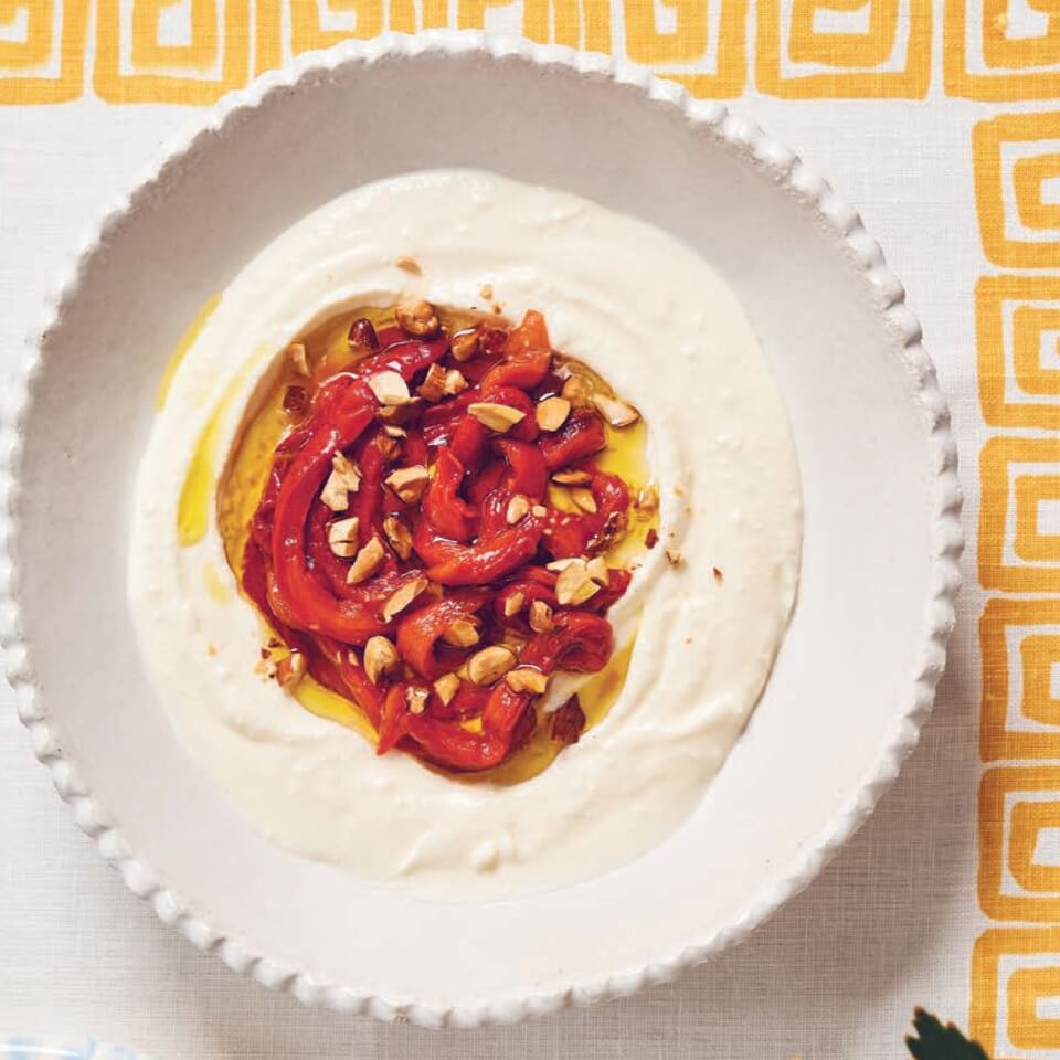 A bowl of whipped feta topped with roasted red peppers