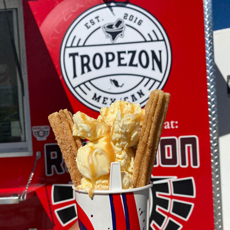 Churros and ice cream in front of a red food truck