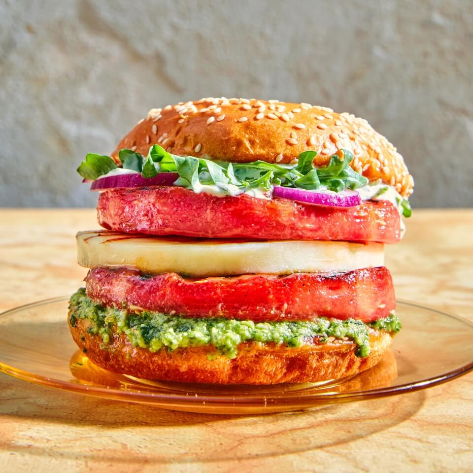 A sandwich with watermelon and paneer on a hamburger bun