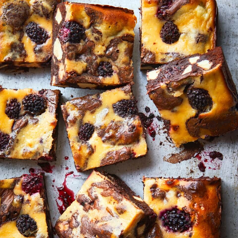 Cheesecake dessert bars with blackberries sliced into small squares