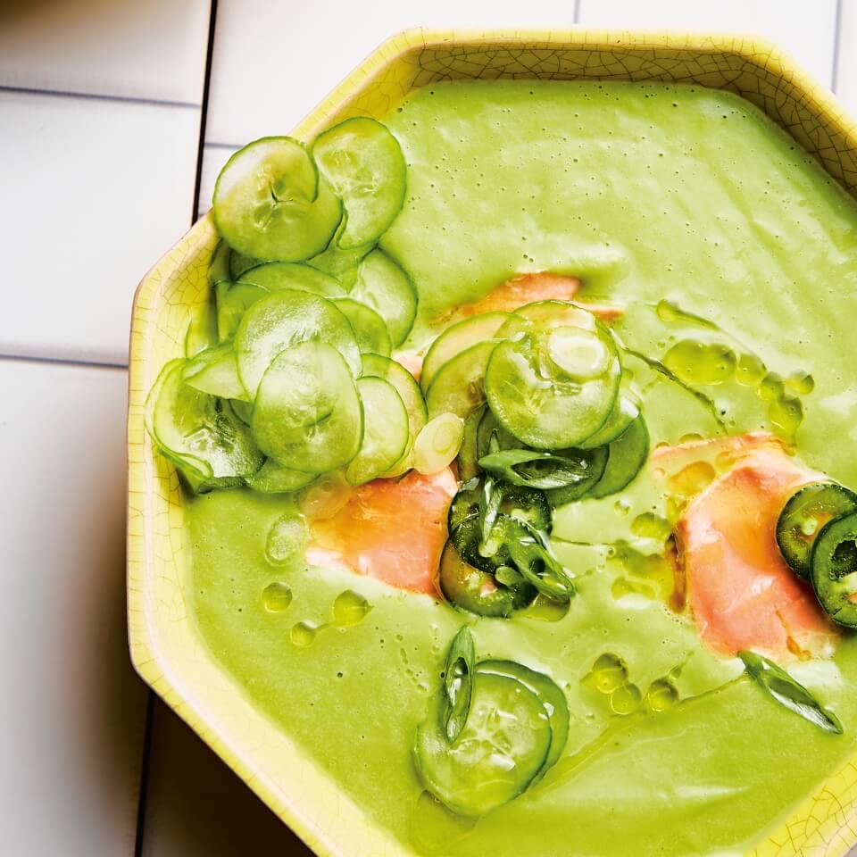 A hexagonal bowl with green gazpacho and salmon