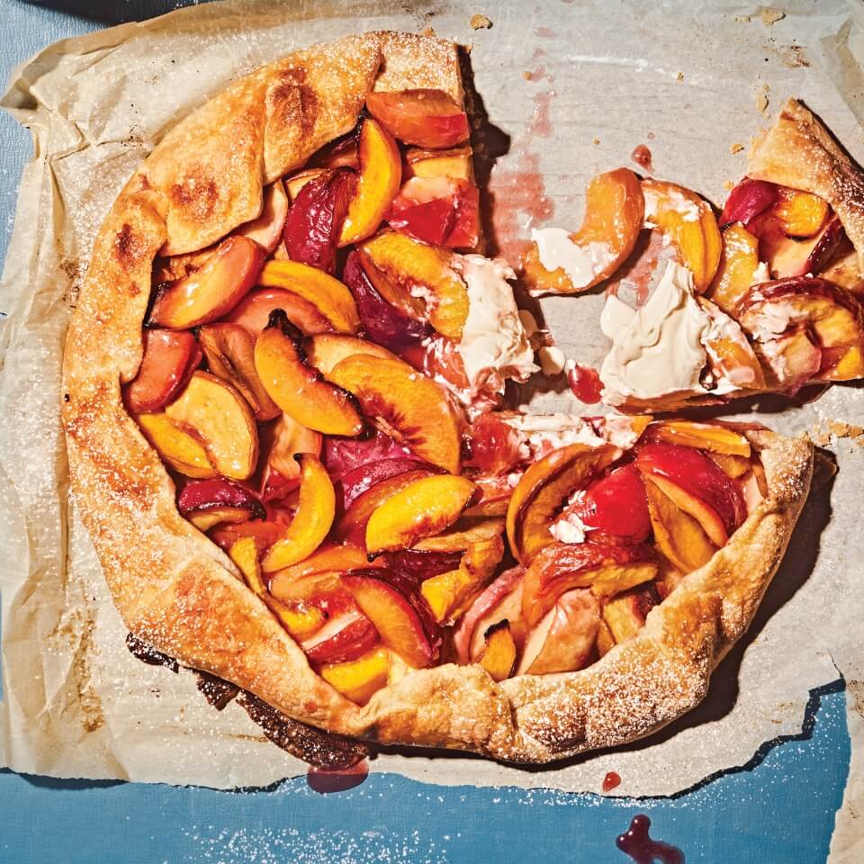 A peach galette on parchment paper