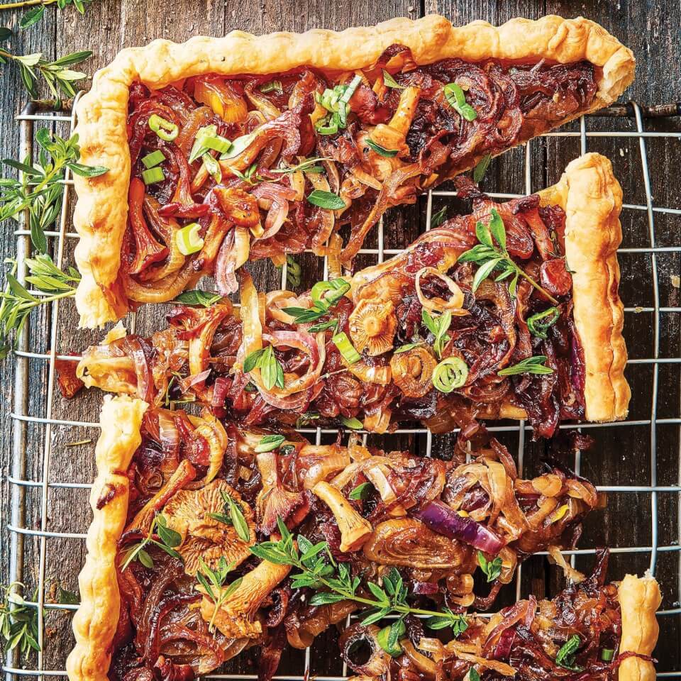 A caramelized onion tart on a drying rack