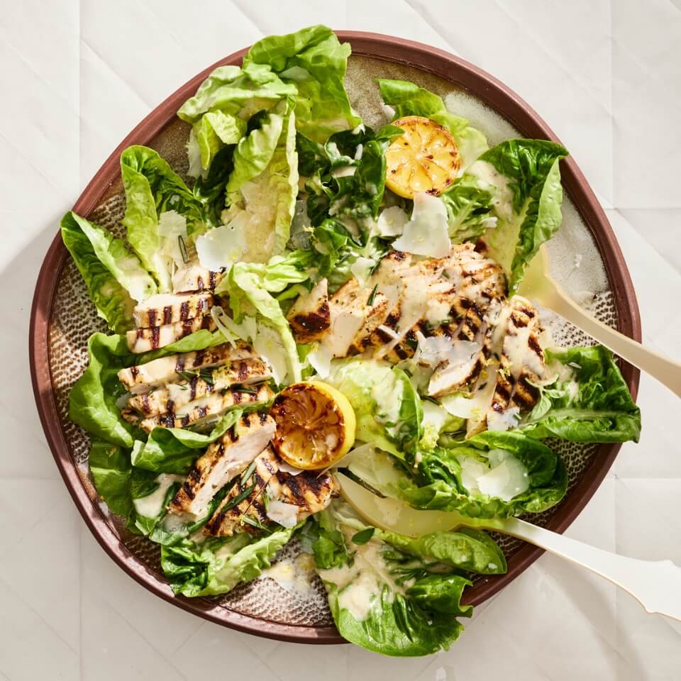 A wooden bowl with Caesar salad