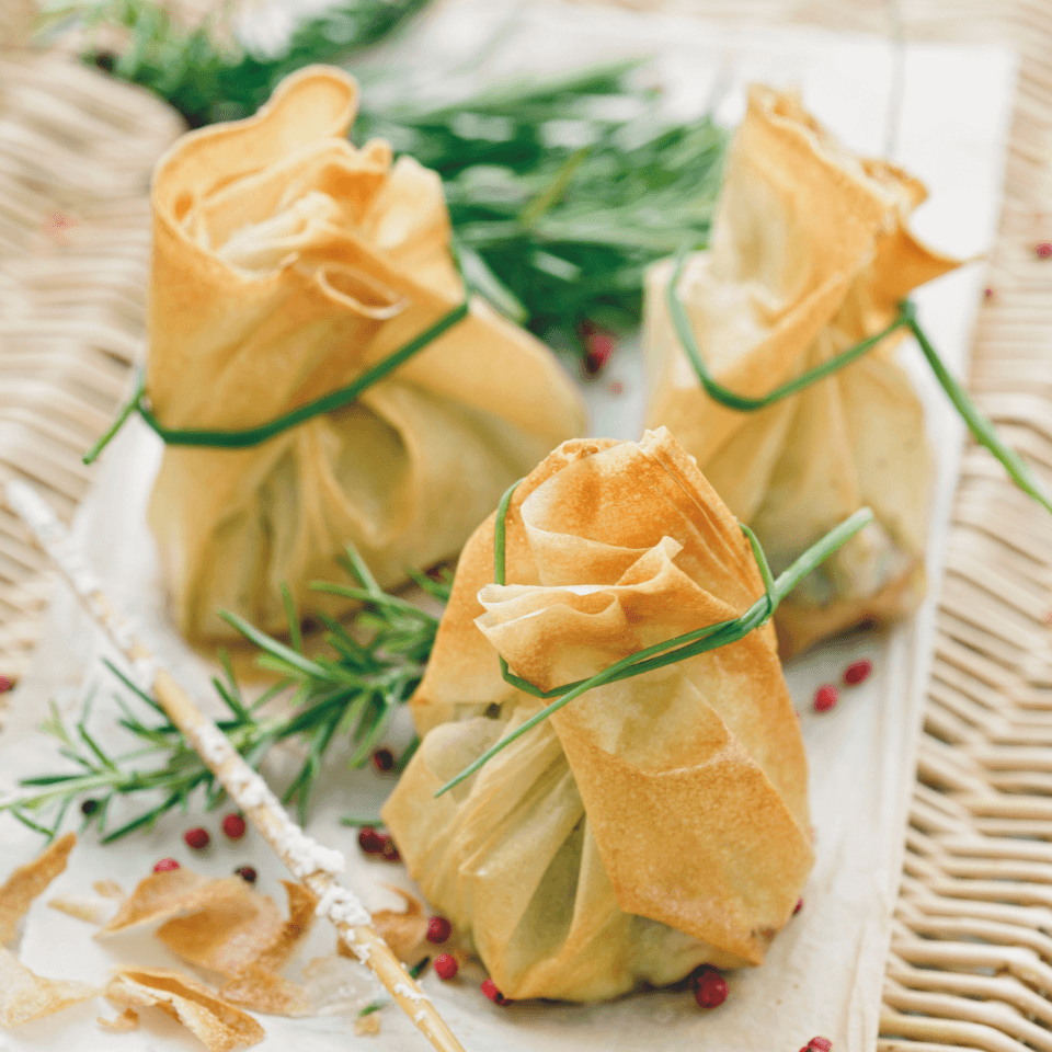 three filo pastry parcels tied with chive