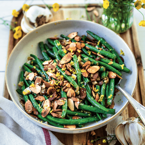 Bowl of green beans with toasted almonds.