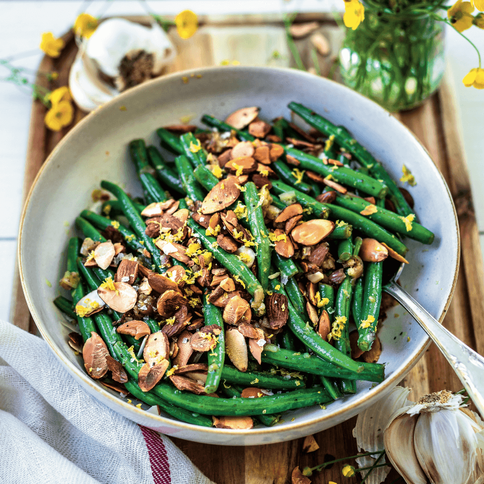 Bowl of green beans with toasted almonds.