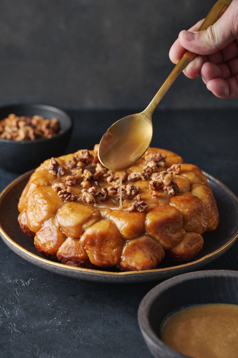 monkey bread with saucebeing spooned on it