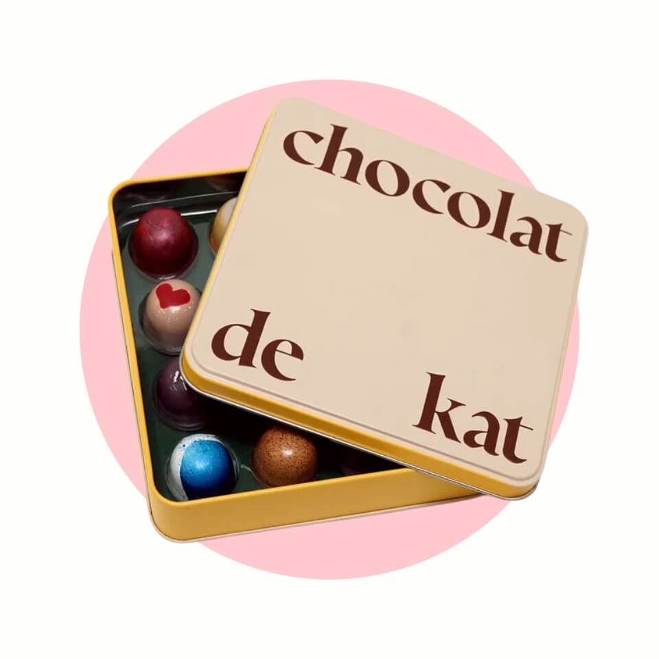 A box of chocolates over a light pink circle