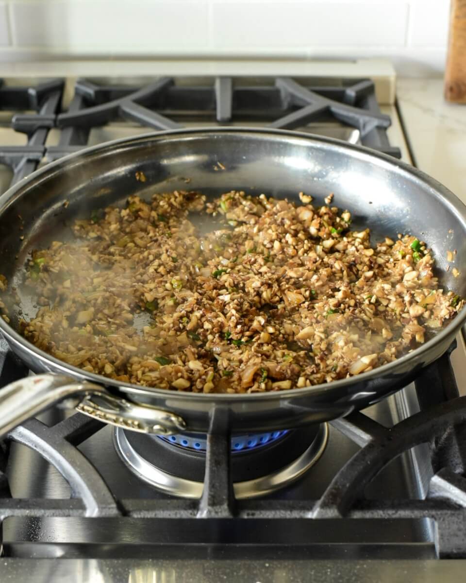 Pan with mushrooms over stove