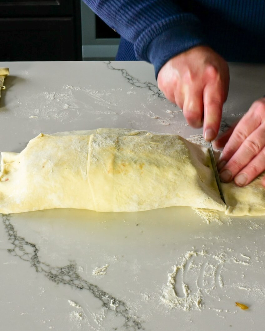 pastry being cut with a knife