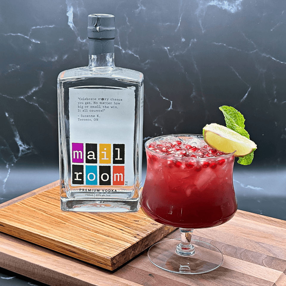 Bottle of Mailroom Vodka and a Pomegranate Mule Cocktail