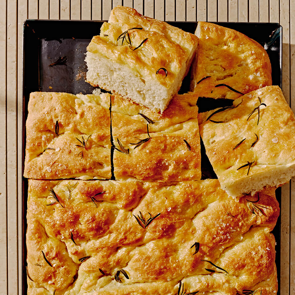 A tray with homemade focaccia sliced into squares