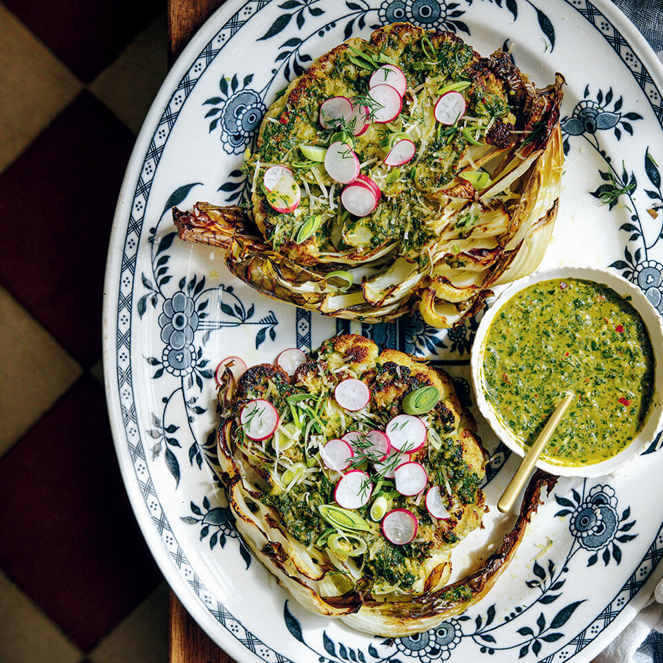 A platter with cauliflower topped with chimichurri