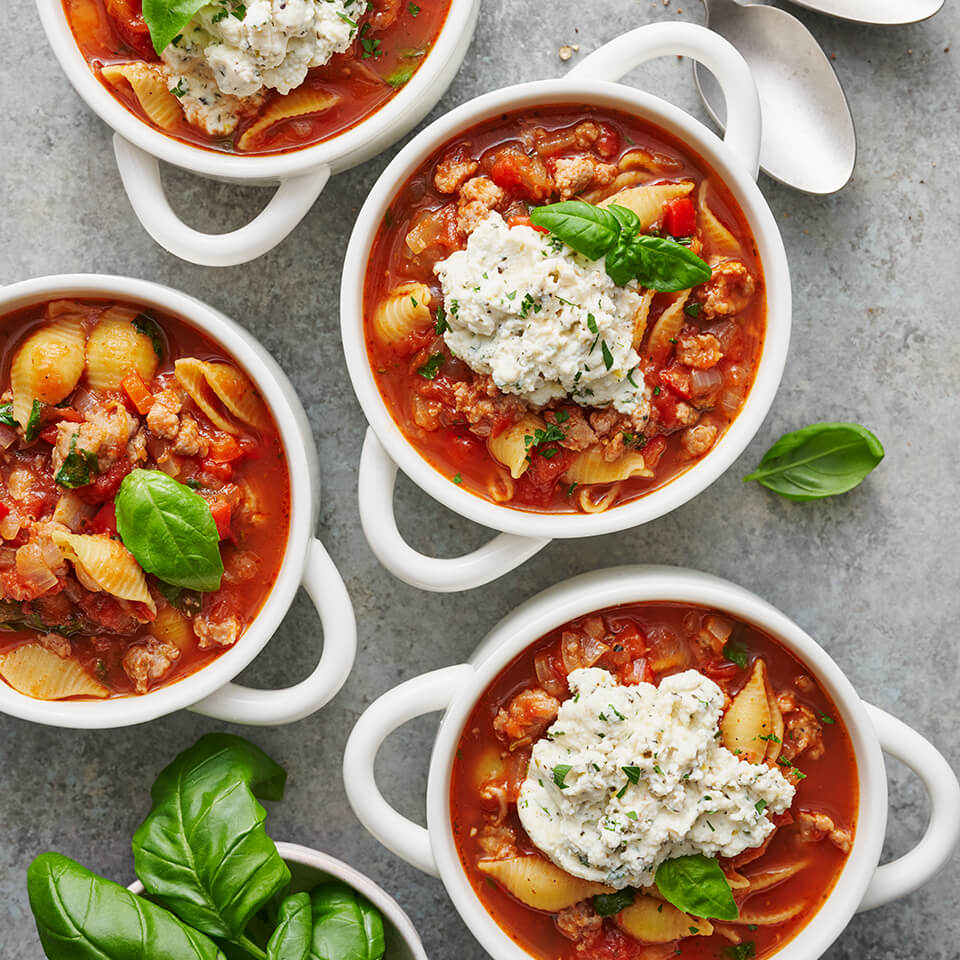 White bowls with pasta soup