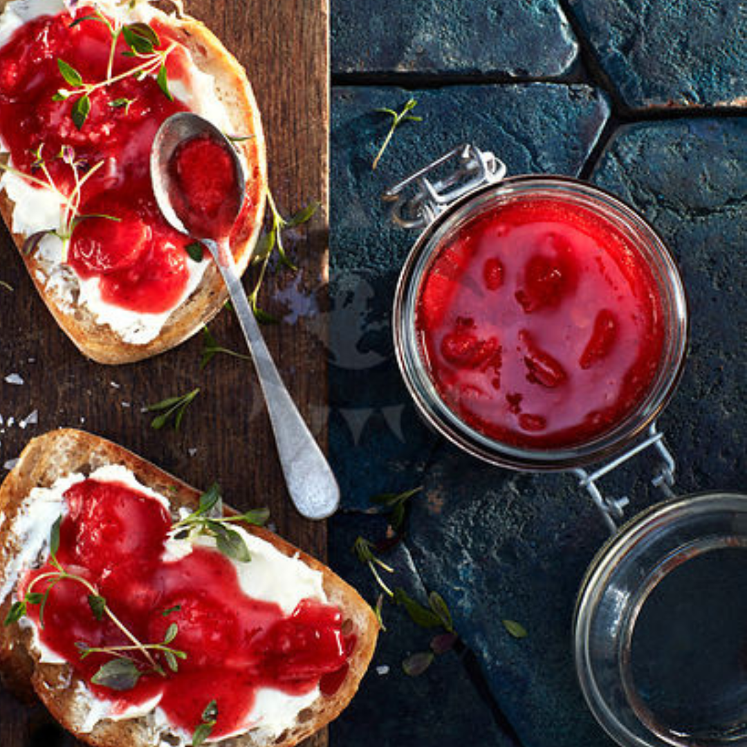Chunky strawberry jam spread on toasted bread on top of cream cheese