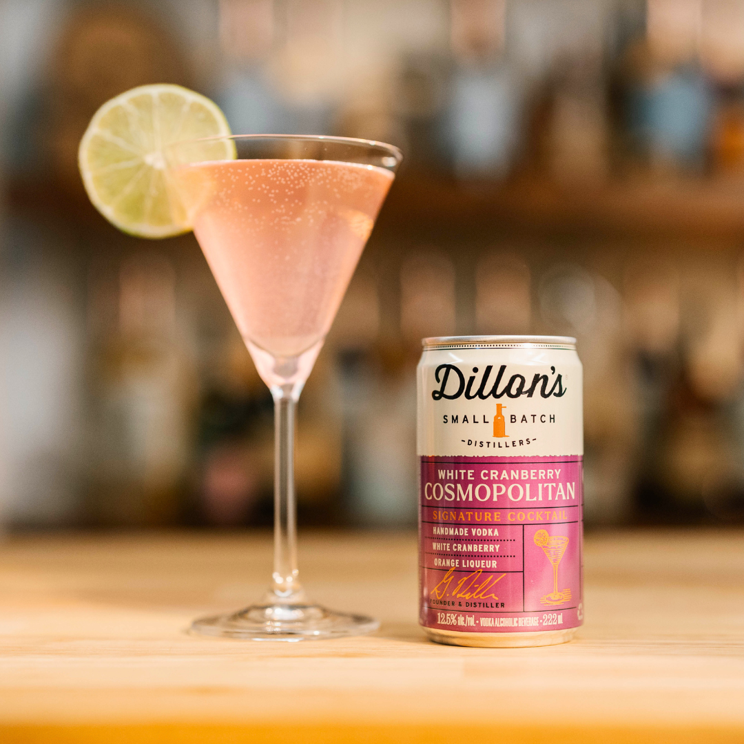 Dillon's distillery can of Small Batch White-Cranberry Cosmopolitan with a glass beside it