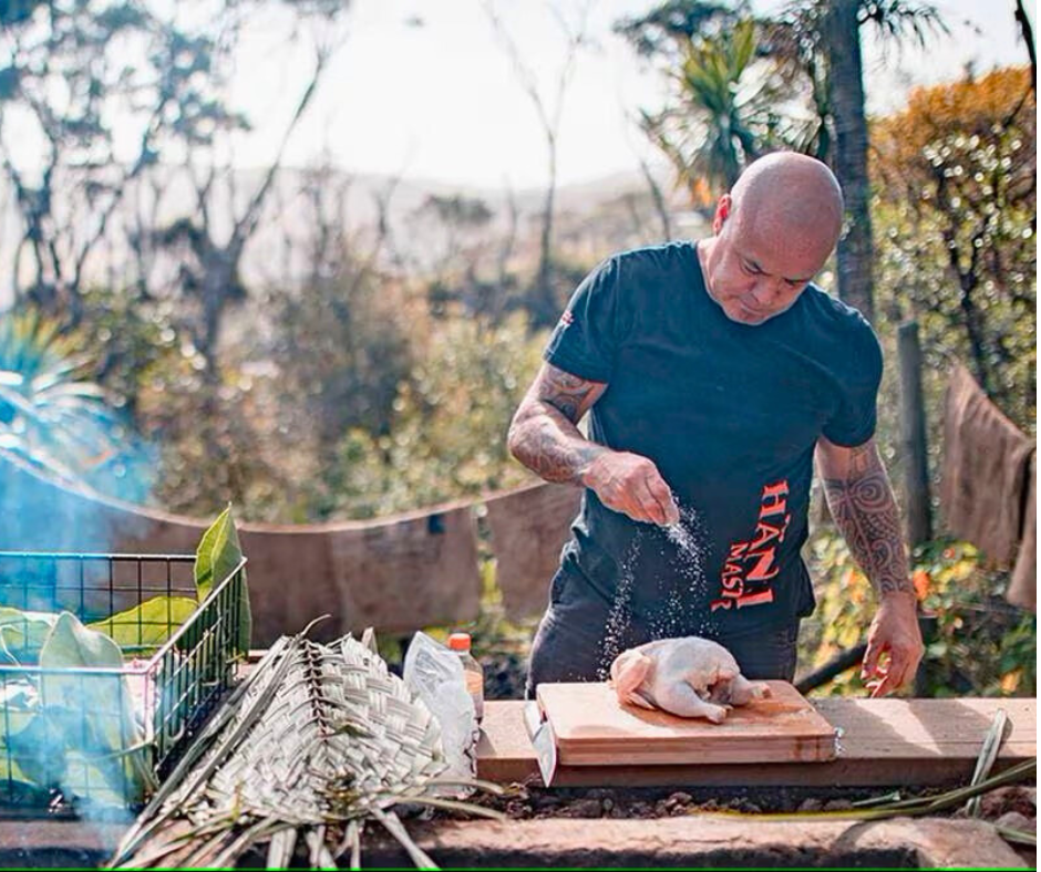 Rewi Spraggon New Zealand’s Hāngi master cooking chicken as part of Maori Food and Wine Experiences