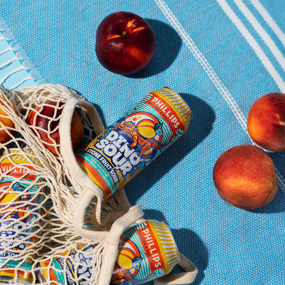 Cans of Dinosour stone fruit sour ale falling out of string bag