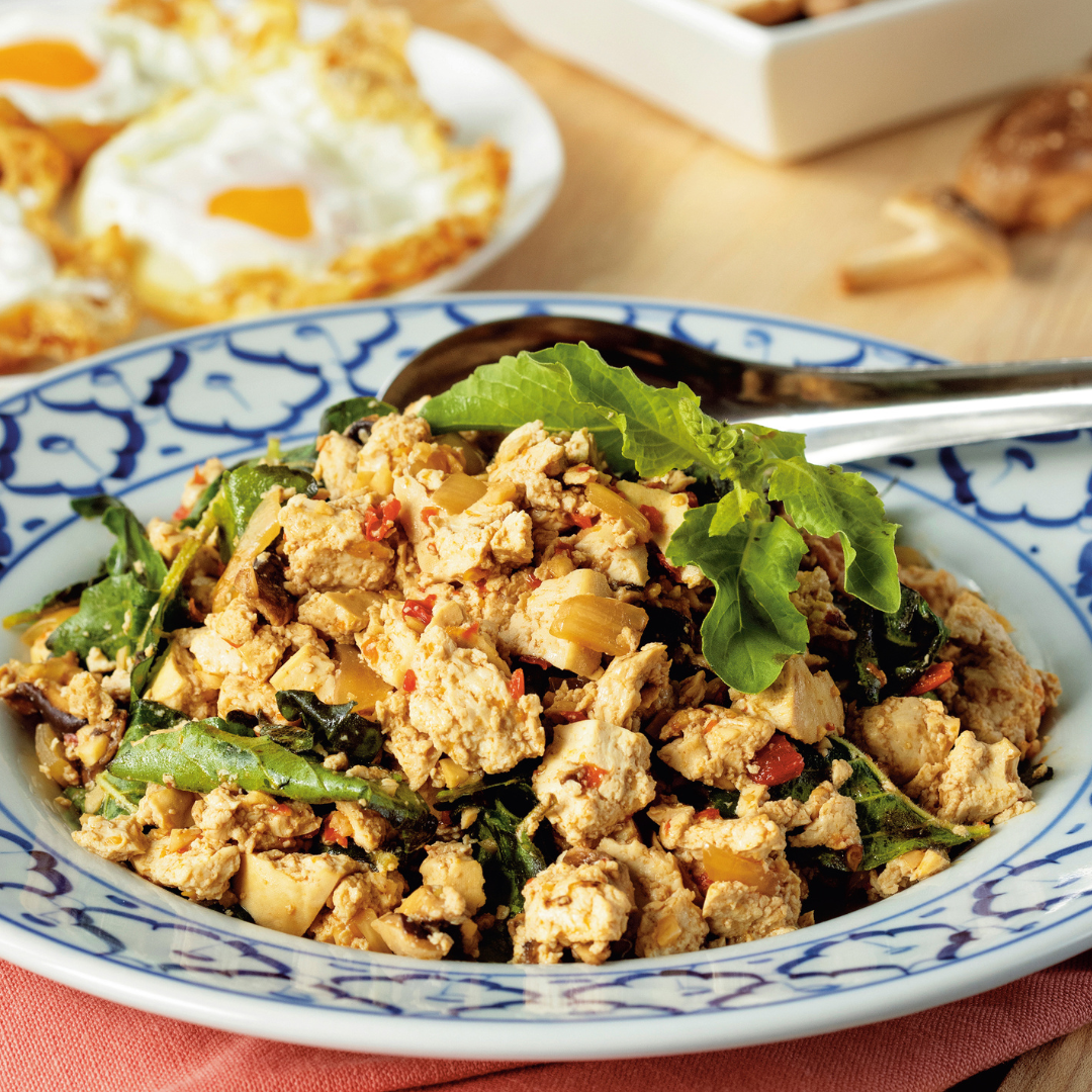 Recipe for mushroom and tofu holy basil stirfry on a pretty blue and white plate