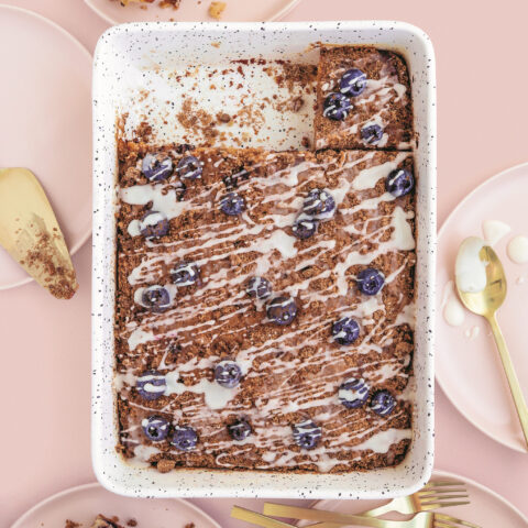 Blueberry breakfast cake in a sheet pan topped with lemon glaze and brown sugar streusel.