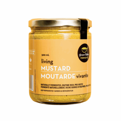 A clear jar of yellow Green Table Foods mustard.