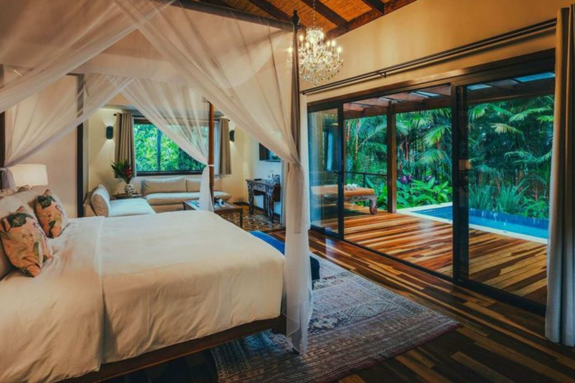 Room in a tented luxury hotel with white king-size bed and plunge pool