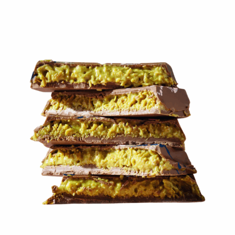 Dubai chocolate bars broken in half to show the pistachio knafeh filling inside.