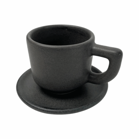 A black ceramic espresso cup on a matching saucer.