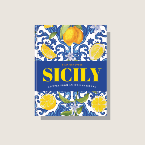 The cover of the Sicily cookbook on a beige background.
