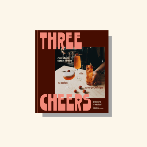 The cover of the Three Cheers cookbook on a beige background.